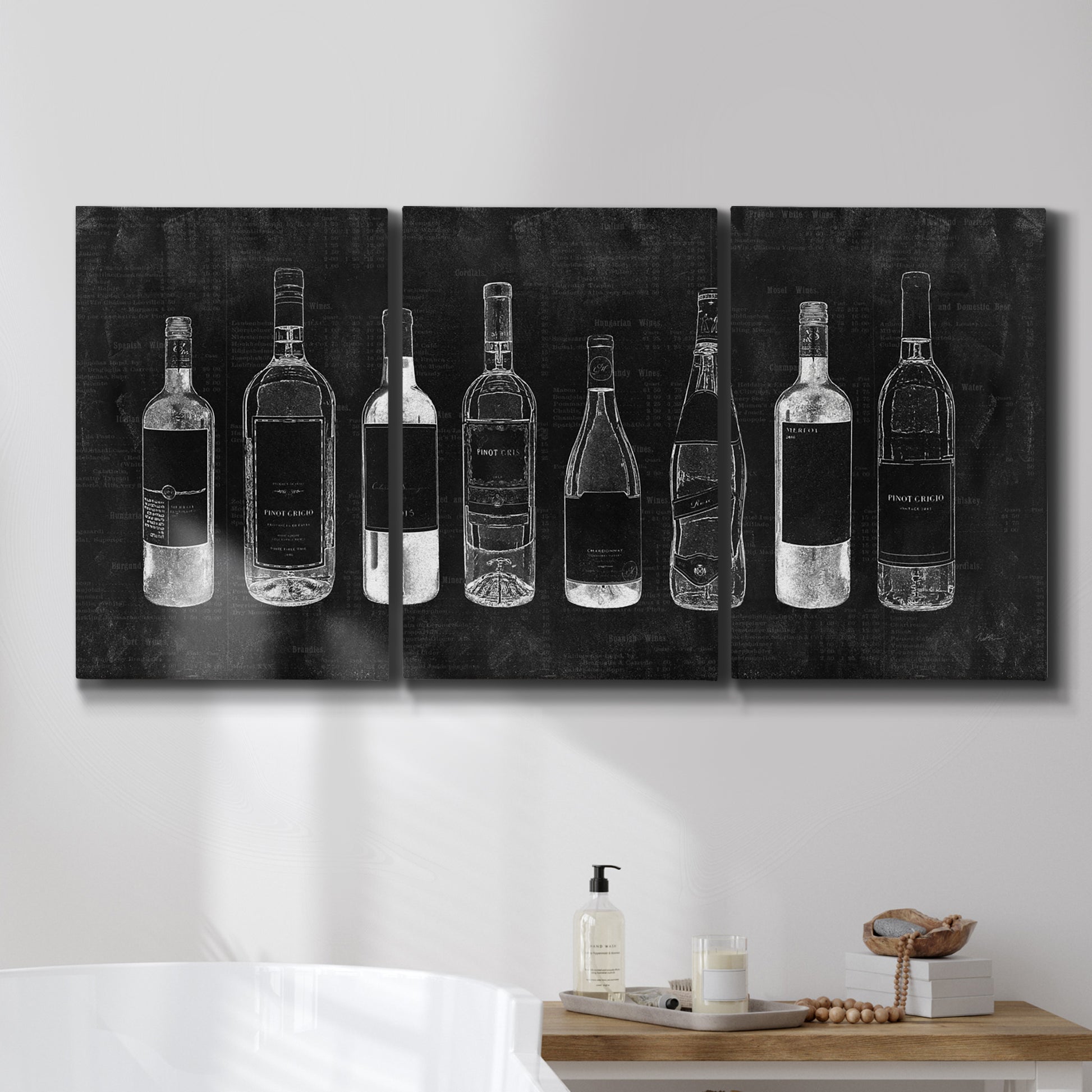 Three-panel canvas wall art featuring illustrated wine bottle cellar diagram, displayed in a bathroom above a bathtub.