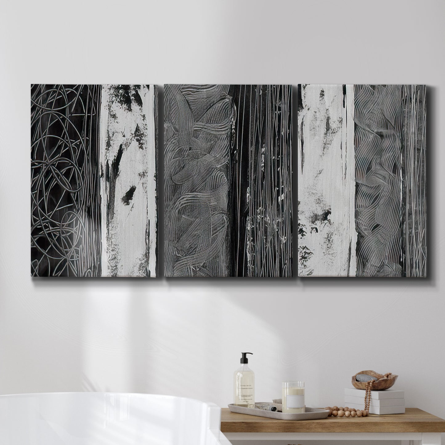 Three-panel canvas wall art featuring brushed metallic abstract textures, displayed in a bathroom above a bathtub.