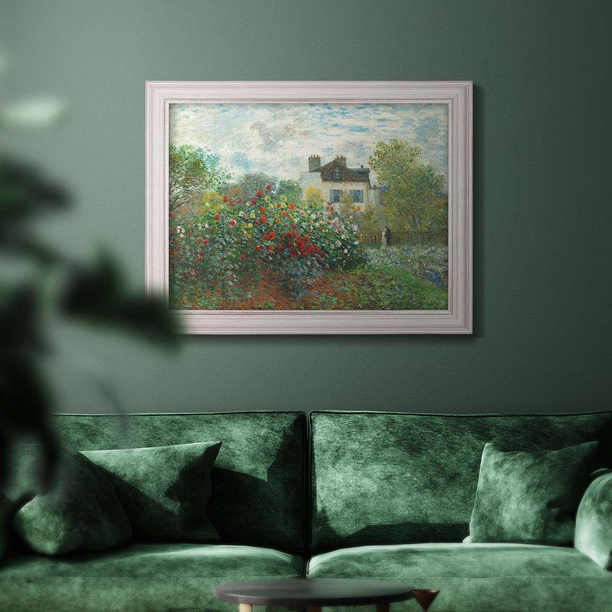 Impressionist garden landscape at Argenteuil by Claude Monet in an ornate weathered white frame displayed in a dark-toned interior setting.