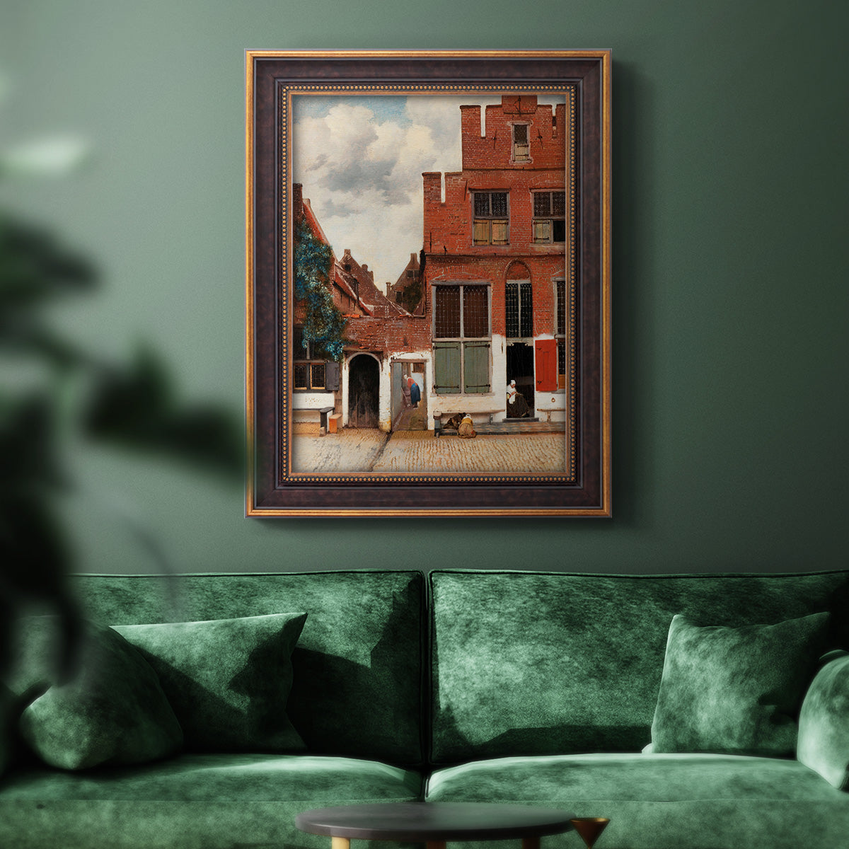 Realist city street scene by Johannes Vermeer in an ornate bronzed mahogany wood frame displayed in a dark-toned interior setting.