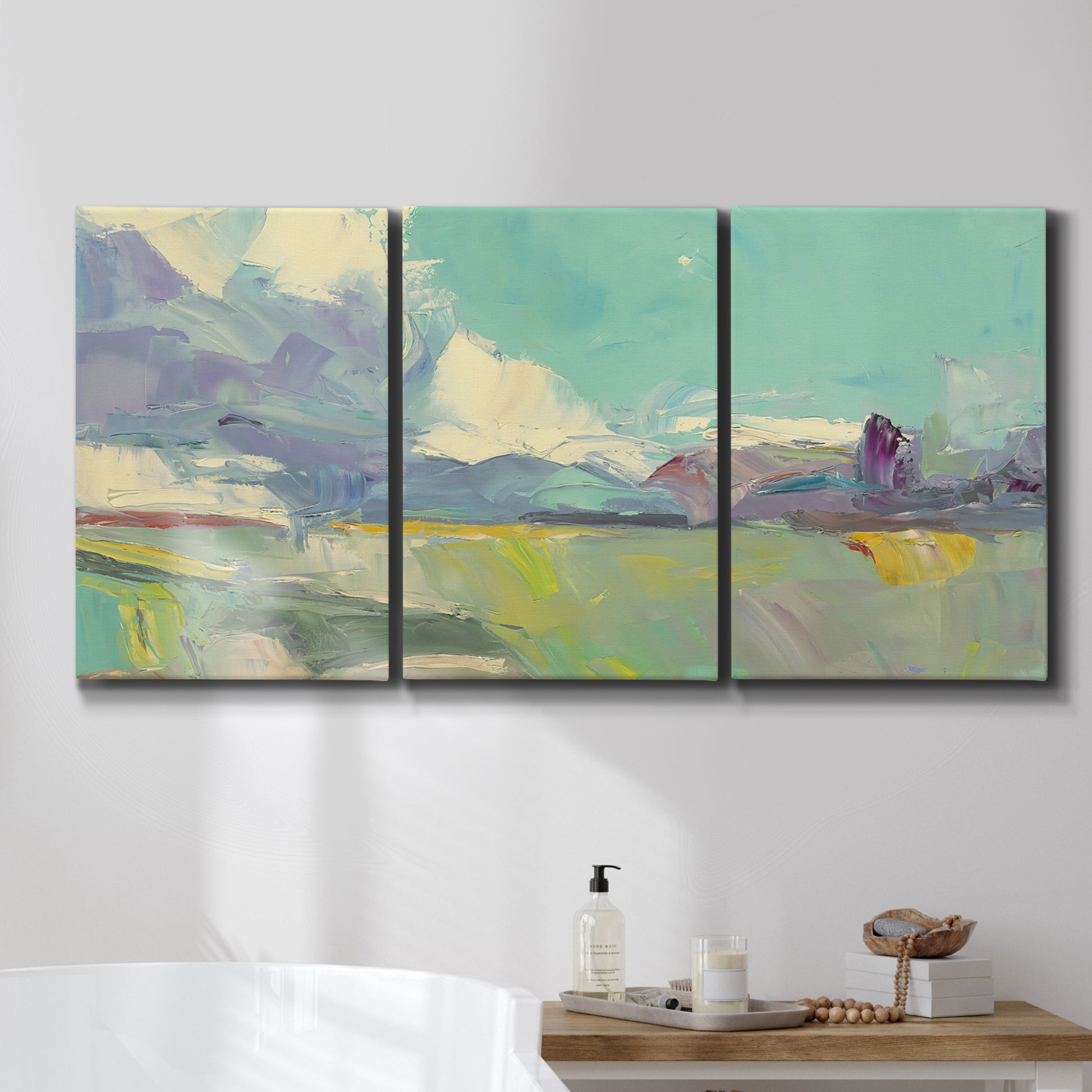 Three-panel canvas wall art featuring road stretching through open countryside, displayed in a bathroom above a bathtub.