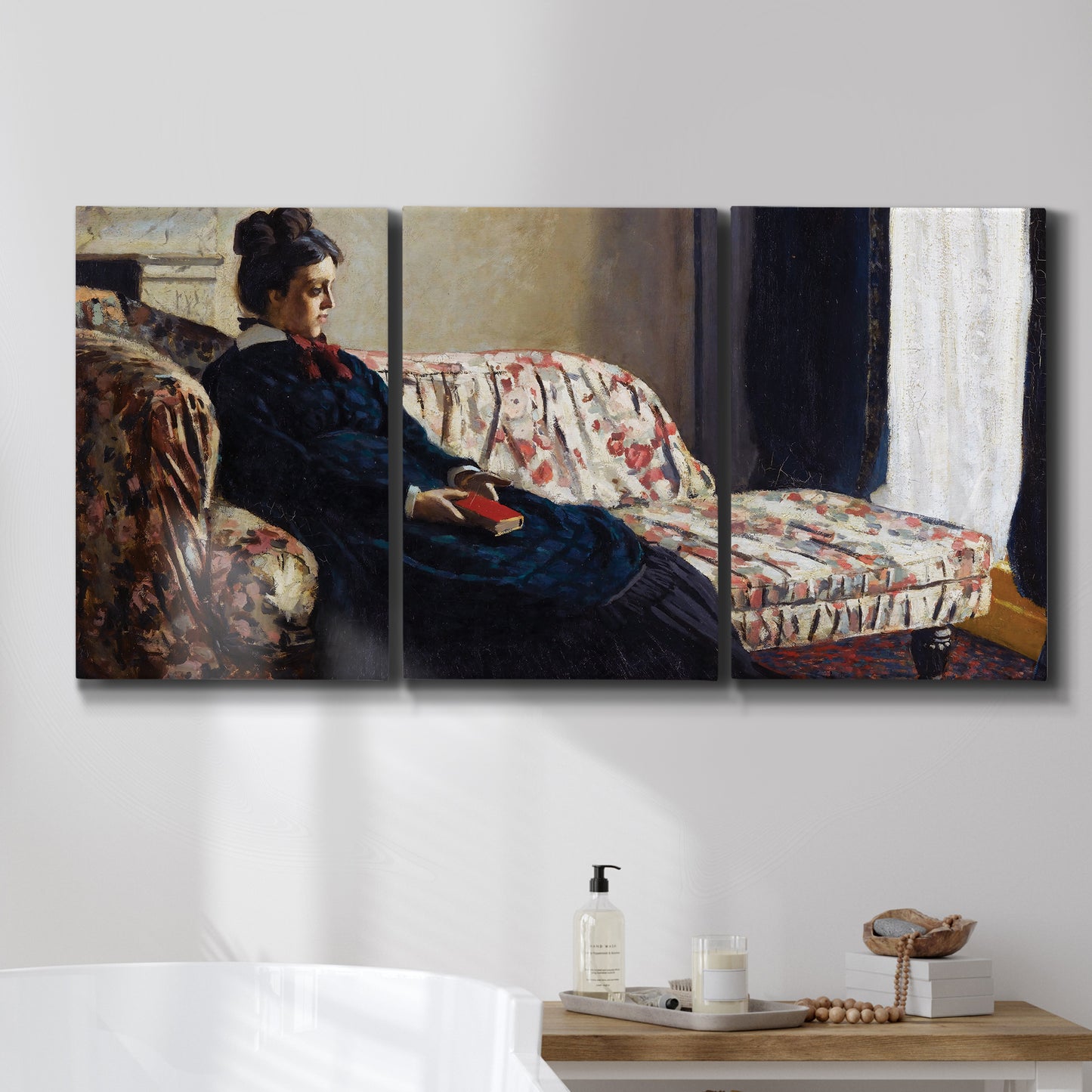 Three-panel canvas wall art featuring woman resting on sofa indoors, displayed in a bathroom above a bathtub.