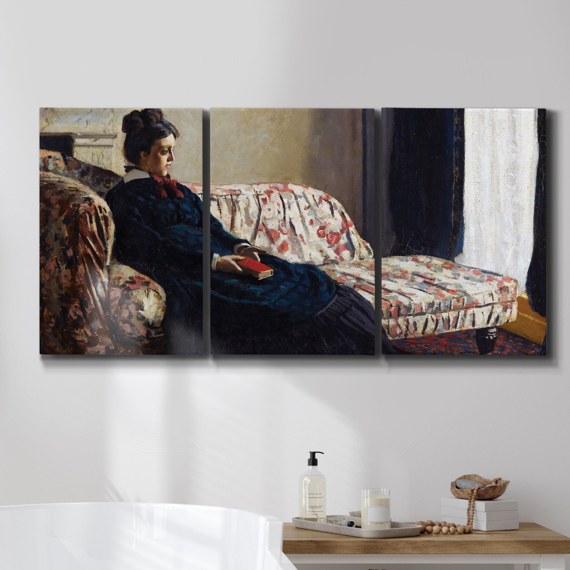 Three-panel canvas wall art featuring woman resting on sofa indoors, displayed in a bathroom above a bathtub.