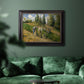 Impressionist countryside harvest scene by Camille Pissarro in an ornate black frame with gilded inner detail displayed in a dark-toned interior setting.