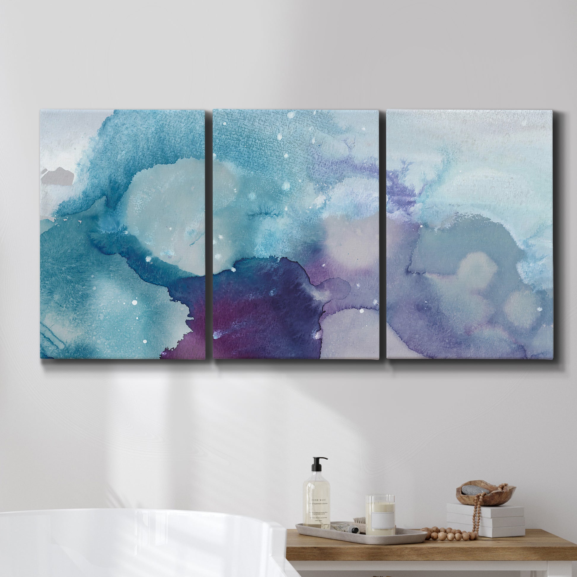 Three-panel canvas wall art featuring icy abstract crystalline forms, displayed in a bathroom above a bathtub.