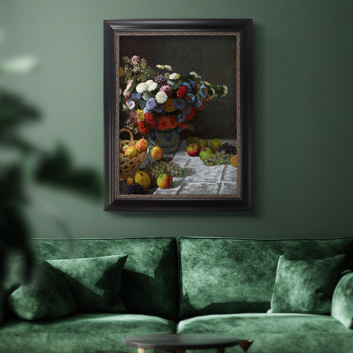 Impressionist floral still life painting by Claude Monet in an ornate black frame with gilded inner detail displayed in a dark-toned interior setting.