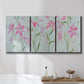 Three-panel canvas wall art featuring pink floral trio arrangement, displayed in a bathroom above a bathtub.