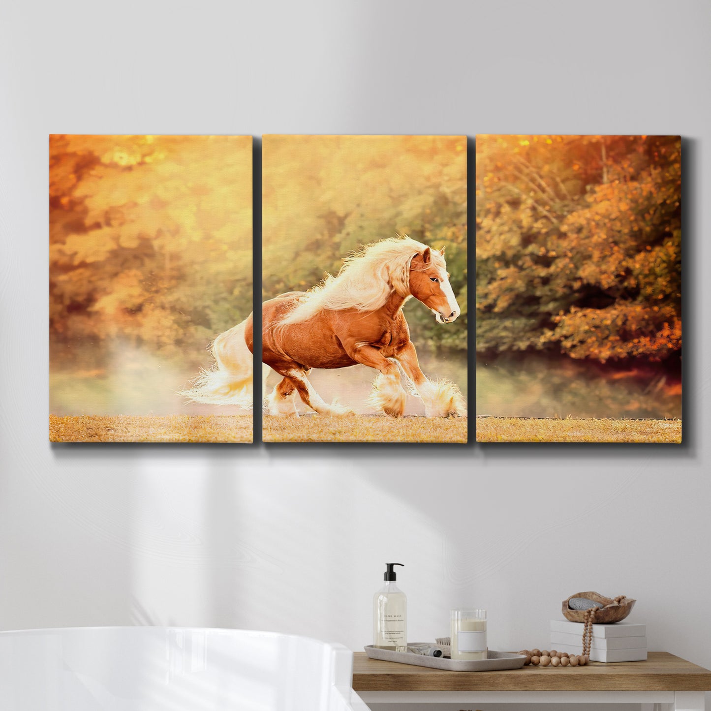 Three-panel canvas wall art featuring running horses captured in motion, displayed in a bathroom above a bathtub.