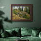 Impressionist countryside harvest scene by Camille Pissarro in an ornate bronzed mahogany wood frame displayed in a dark-toned interior setting.