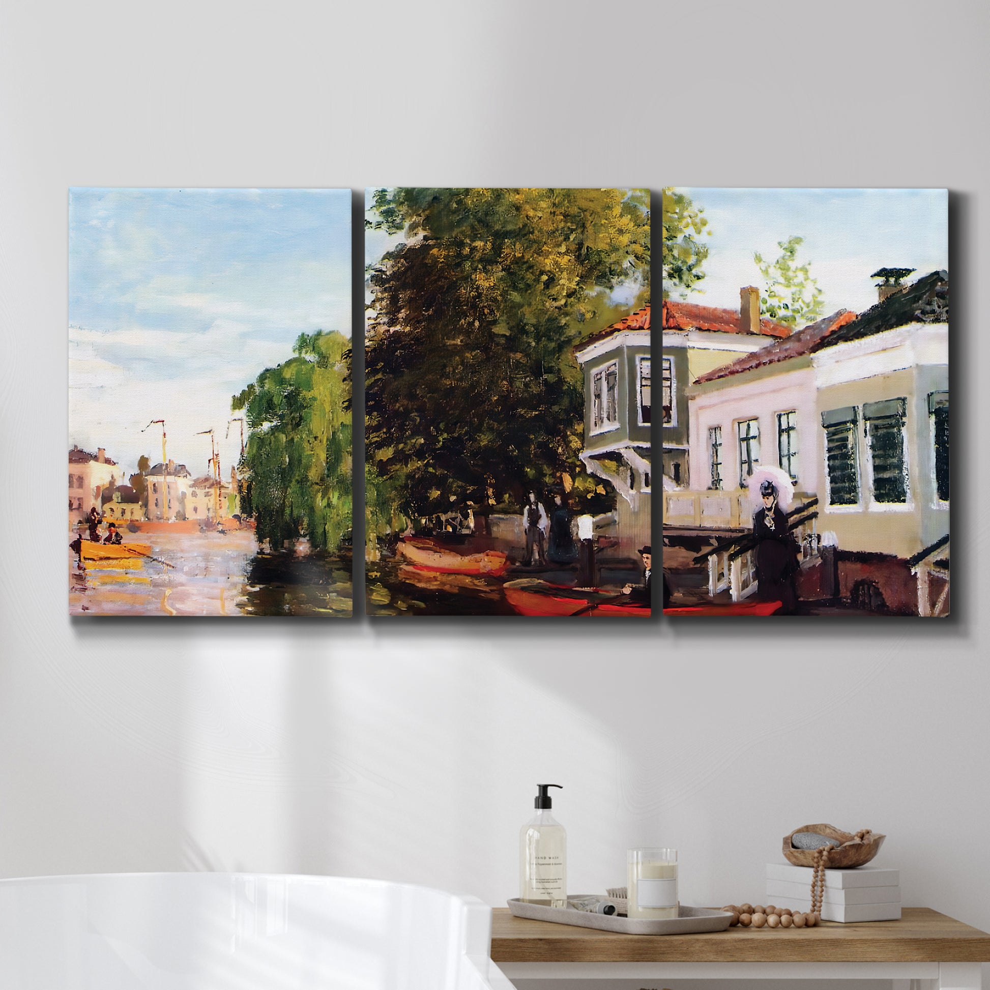 Three-panel canvas wall art featuring riverside houses along canal, displayed in a bathroom above a bathtub.