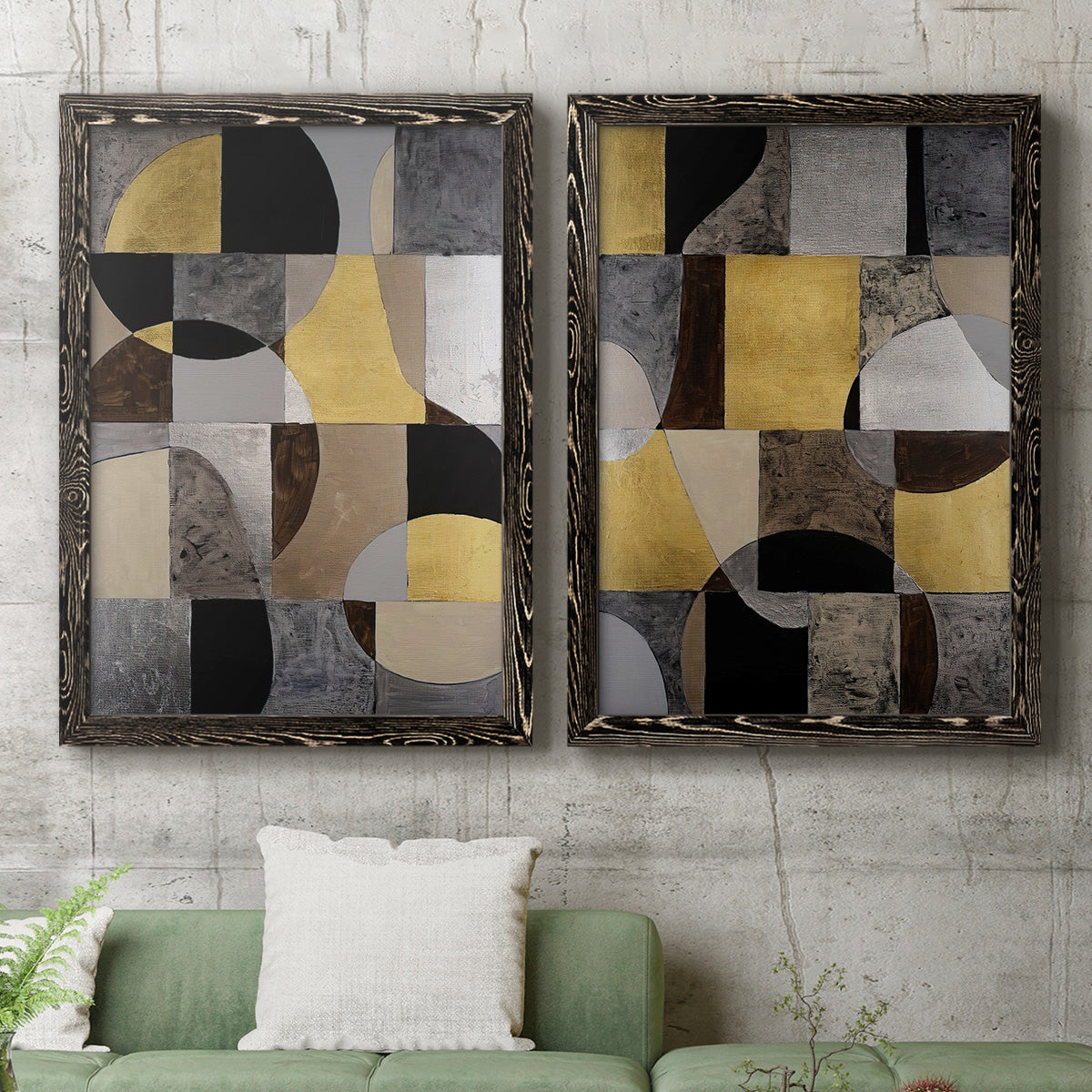 Set of two black barnwood framed canvas prints depicting a coordinated art pair of interlocking black gray cream and gold geometric sections rendered as structured modern abstracts above a sofa in a modern living room.