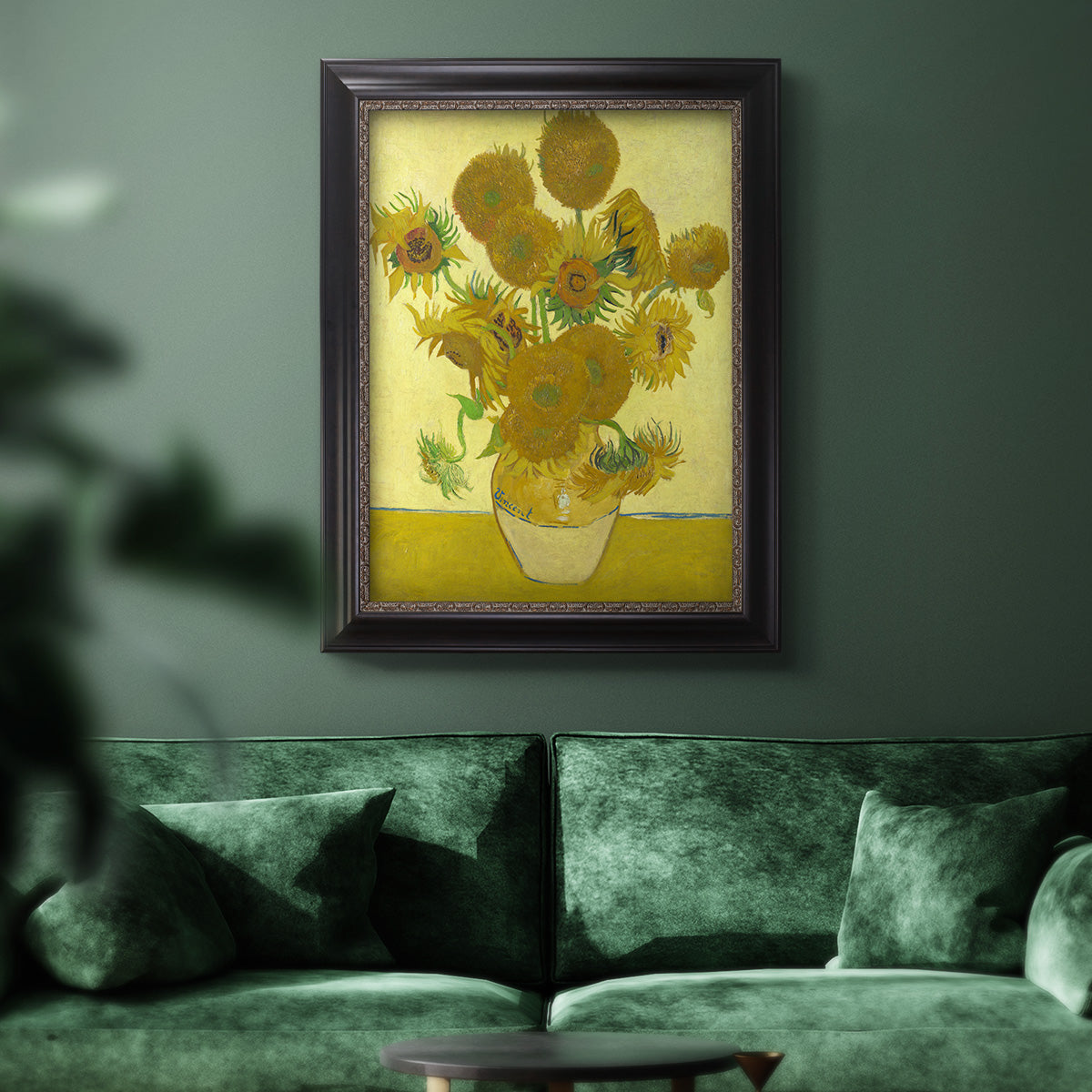 Impressionist sunflower still life painting by Vincent van Gogh in an ornate black frame with gilded inner detail displayed in a dark-toned interior setting.
