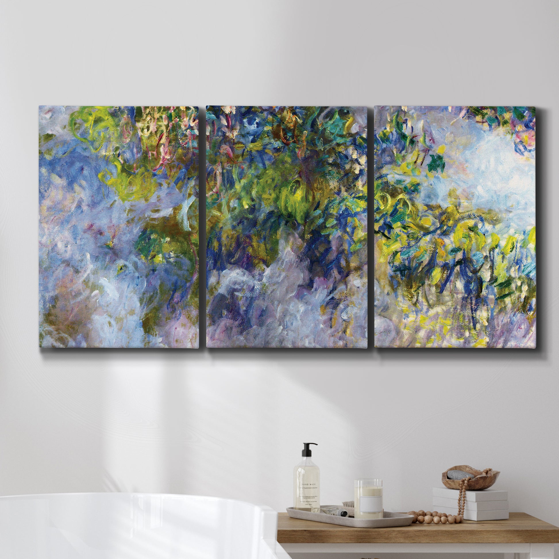 Three-panel canvas wall art featuring cascading purple wisteria blooms, displayed in a bathroom above a bathtub.