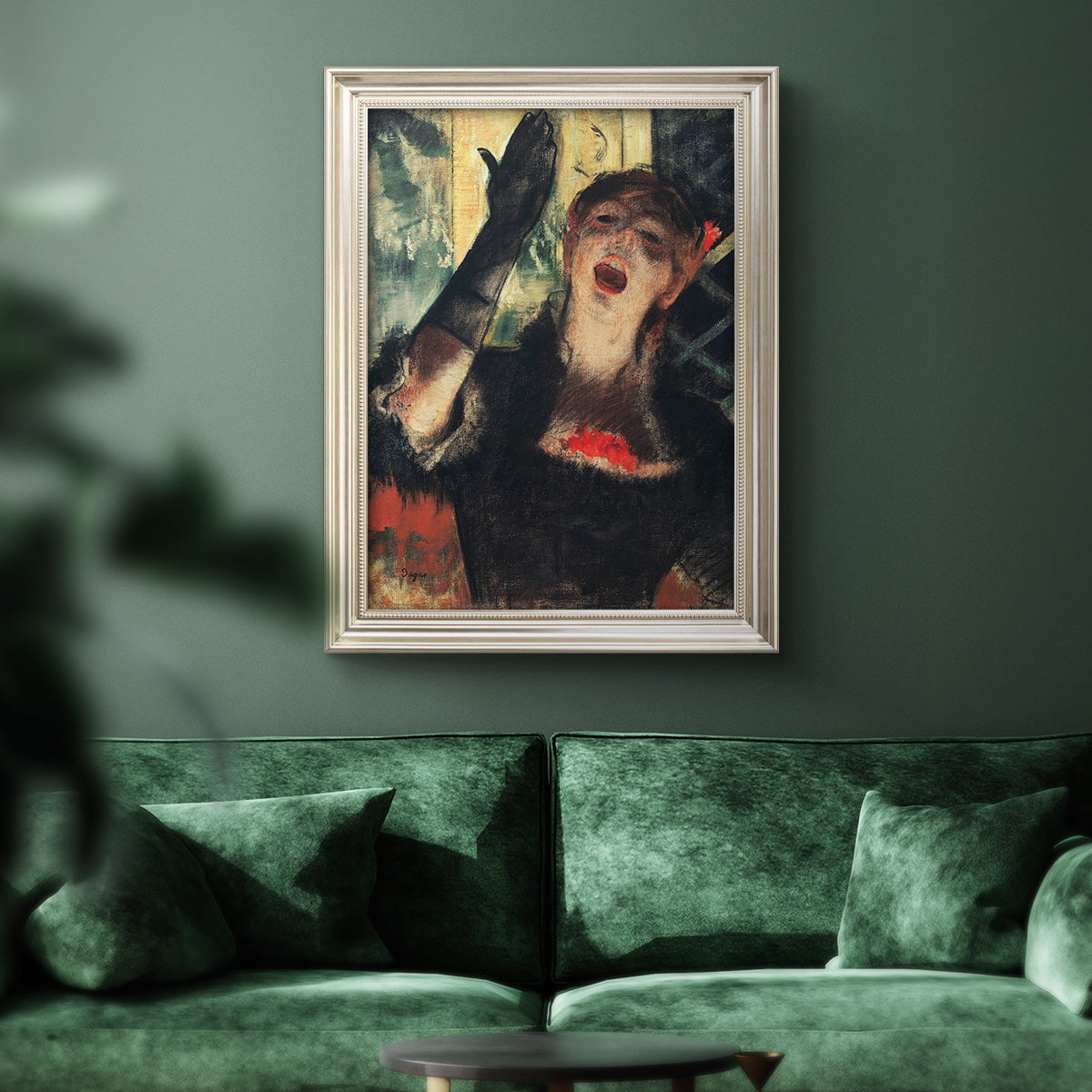 Impressionist portrait of a café singer by Edgar Degas in an ornate champagne frame displayed in a dark-toned interior setting.