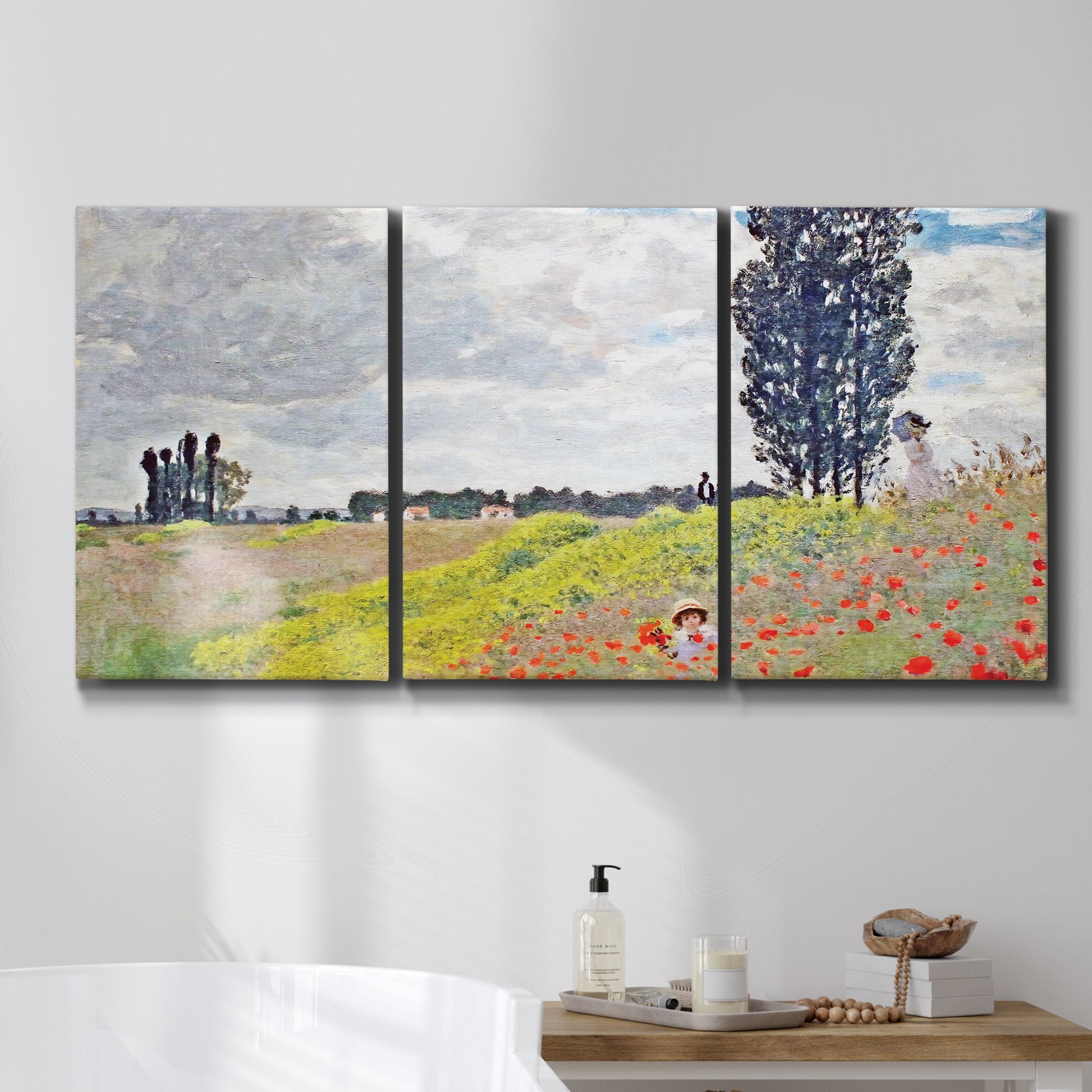 Three-panel canvas wall art featuring open poppy field in countryside, displayed in a bathroom above a bathtub.