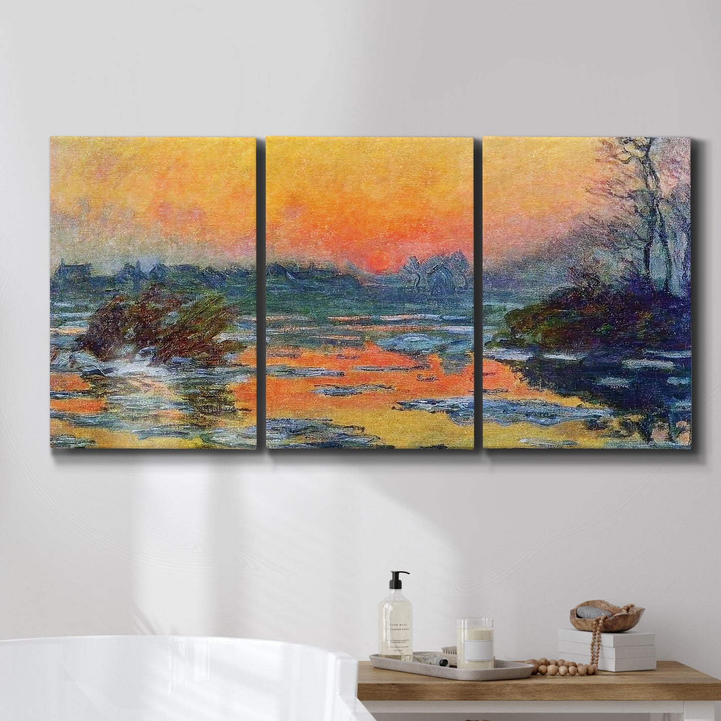 Three-panel canvas wall art featuring winter sunset over river, displayed in a bathroom above a bathtub.