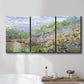 Three-panel canvas wall art featuring spring orchard in full bloom, displayed in a bathroom above a bathtub.
