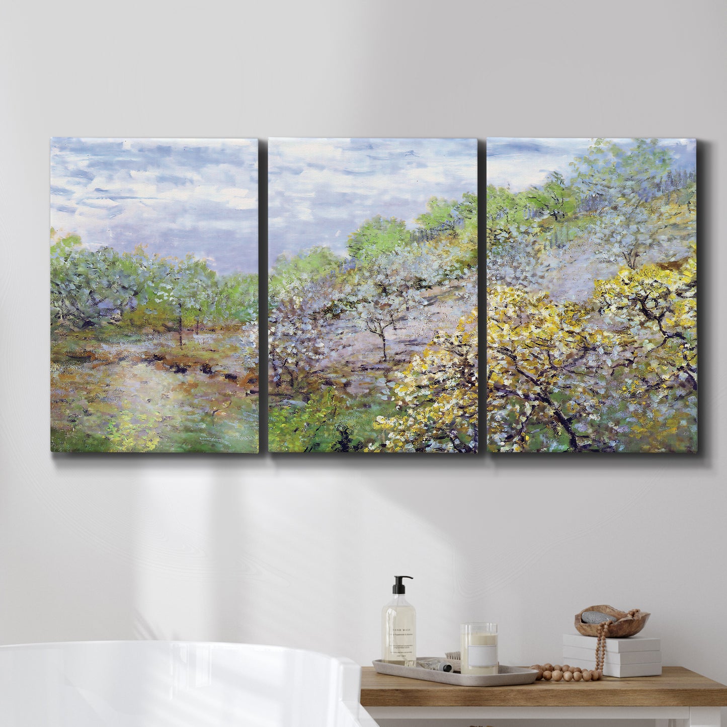Three-panel canvas wall art featuring spring orchard in full bloom, displayed in a bathroom above a bathtub.