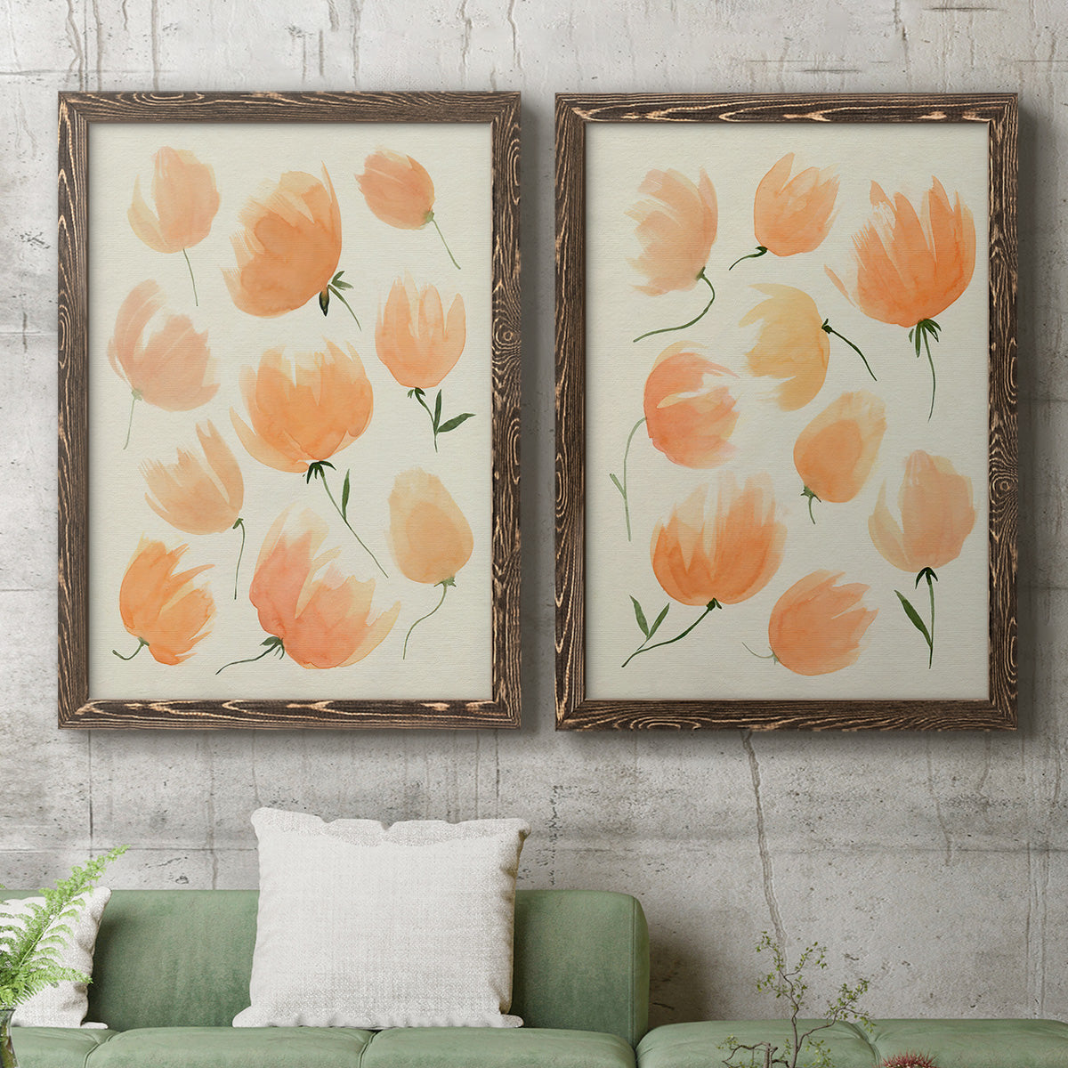 Set of two walnut barnwood framed canvas prints depicting a coordinated art pair of loose peach-orange tulip-like blossoms rendered as airy watercolor floral paintings above a sofa in a modern living room.