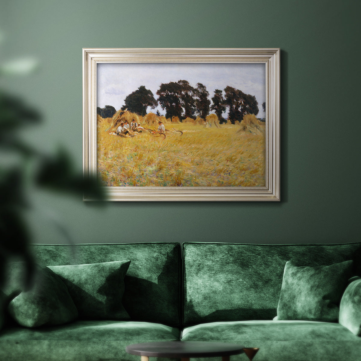 Impressionist rural harvest scene by John Singer Sargent in an ornate champagne frame displayed in a dark-toned interior setting.