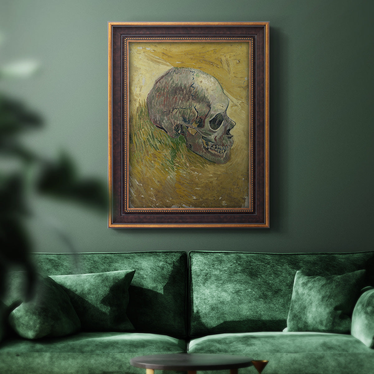 Profile skull study artwork by Vincent van Gogh in an ornate bronzed mahogany wood frame displayed in a dark-toned interior setting.