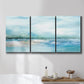 Three-panel canvas wall art featuring sunset silhouette over coastal water, displayed in a bathroom above a bathtub.
