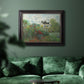 Impressionist garden landscape at Argenteuil by Claude Monet in an ornate black frame with gilded inner detail displayed in a dark-toned interior setting.