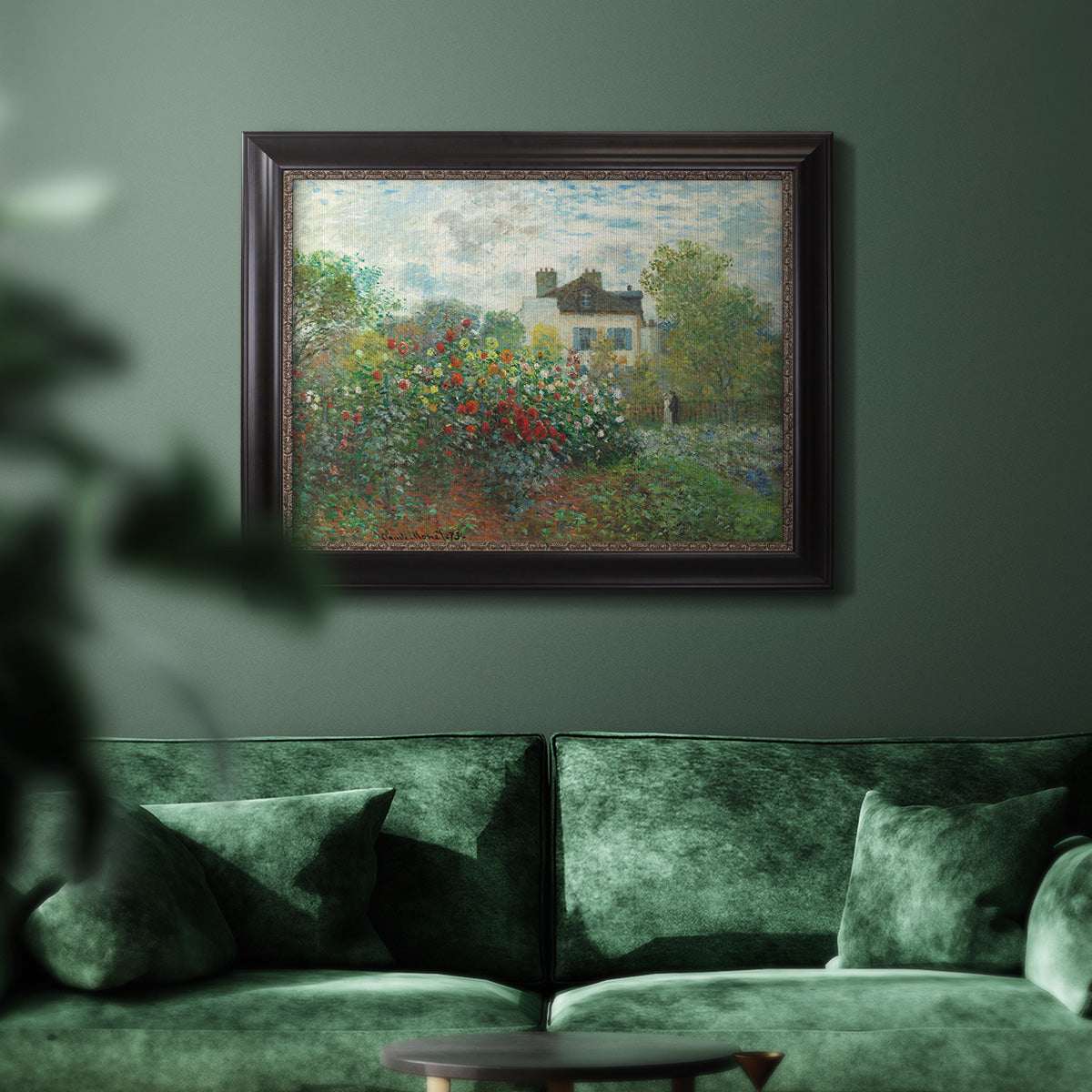 Impressionist garden landscape at Argenteuil by Claude Monet in an ornate black frame with gilded inner detail displayed in a dark-toned interior setting.