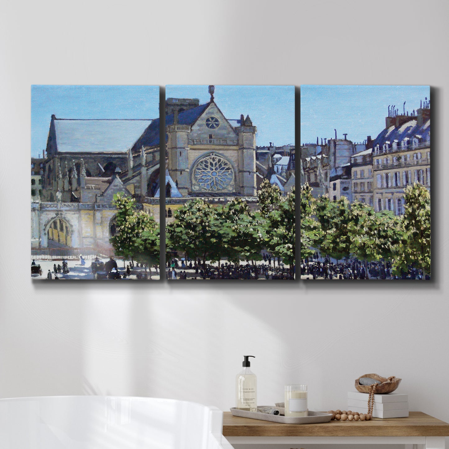 Three-panel canvas wall art featuring gothic church within city setting, displayed in a bathroom above a bathtub.