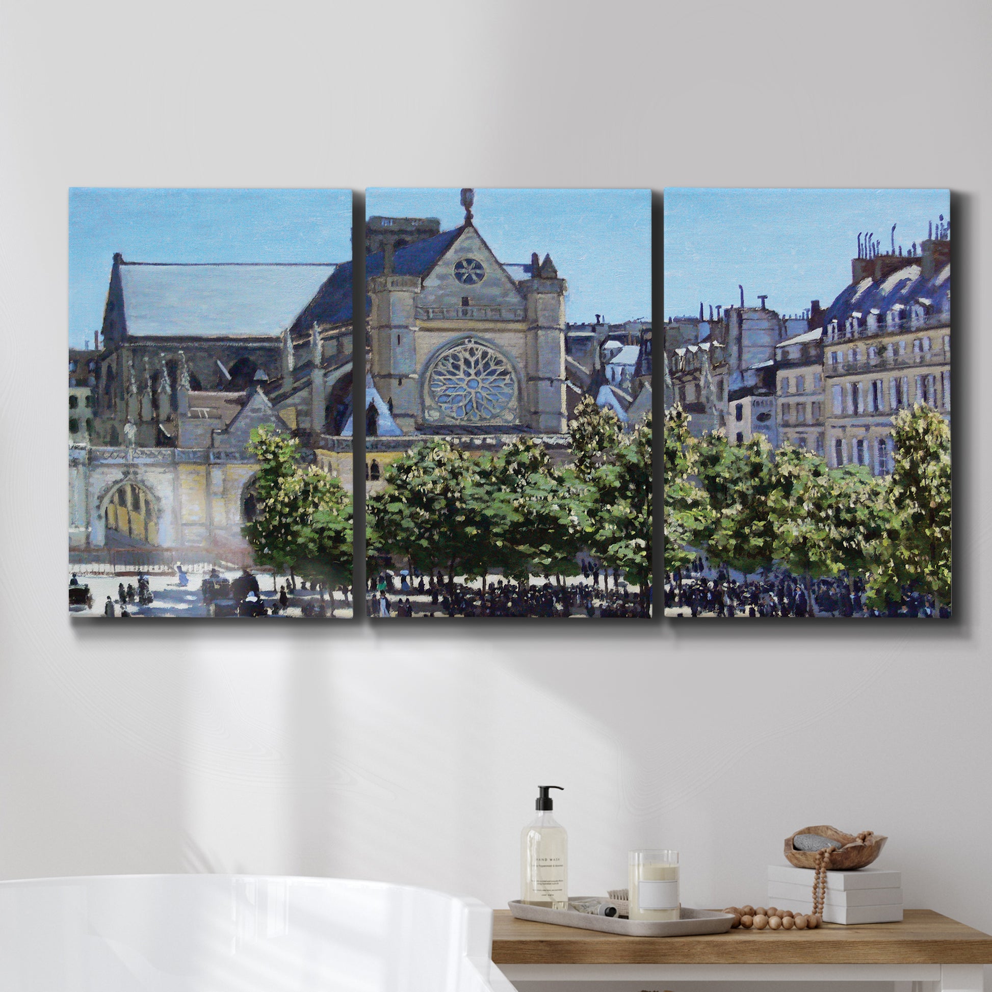 Three-panel canvas wall art featuring gothic church within city setting, displayed in a bathroom above a bathtub.