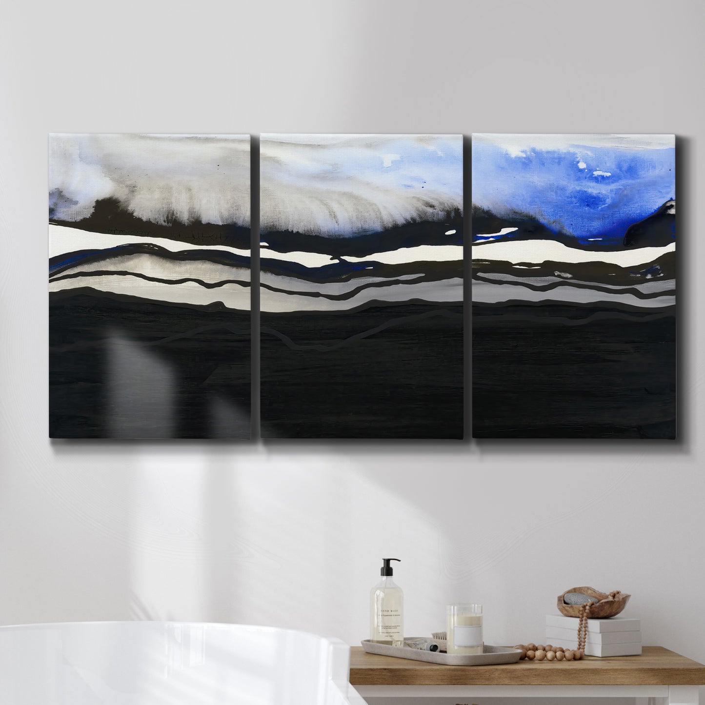 Three-panel canvas wall art featuring abstract passage of time composition, displayed in a bathroom above a bathtub.