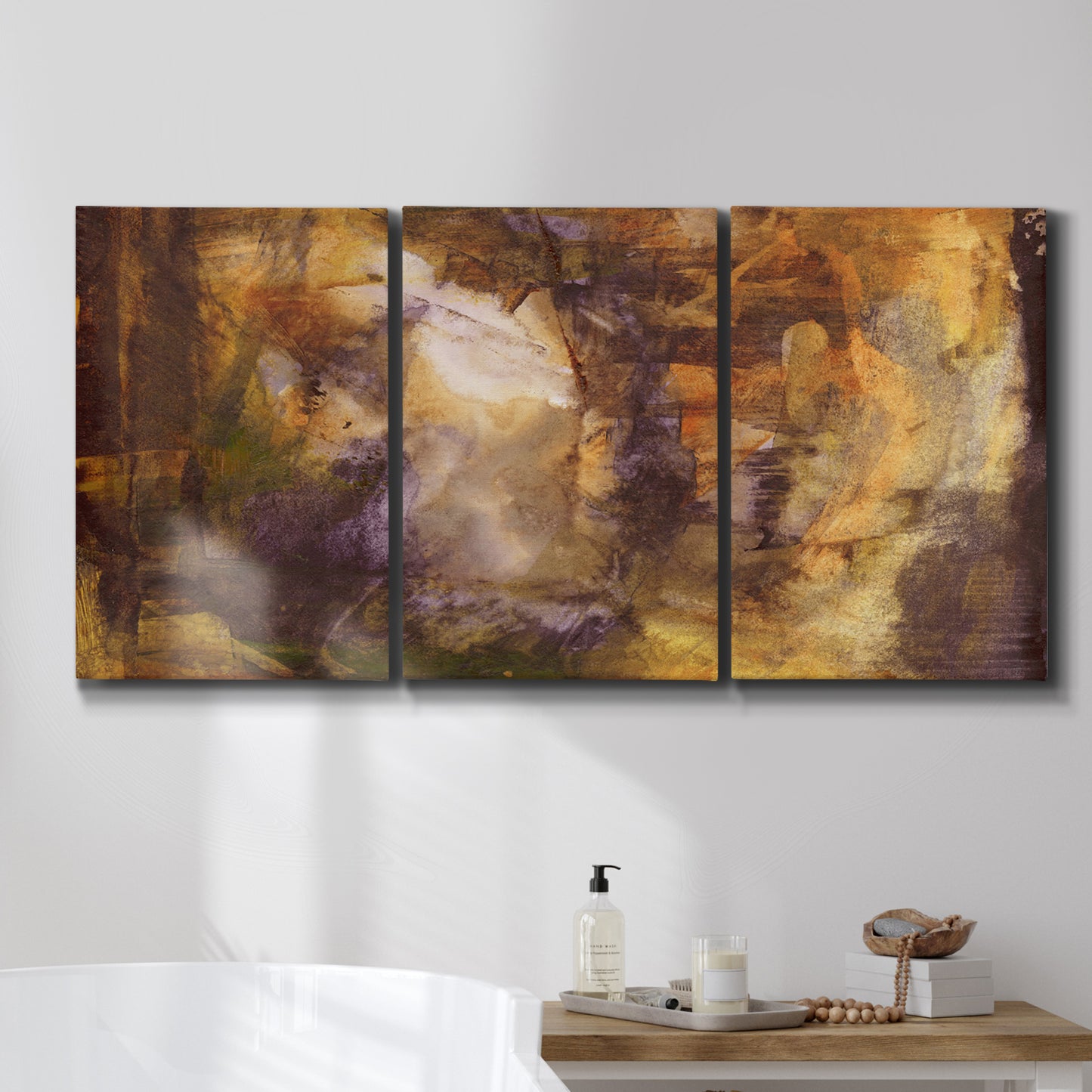 Three-panel canvas wall art featuring abstract architectural landscape, displayed in a bathroom above a bathtub.