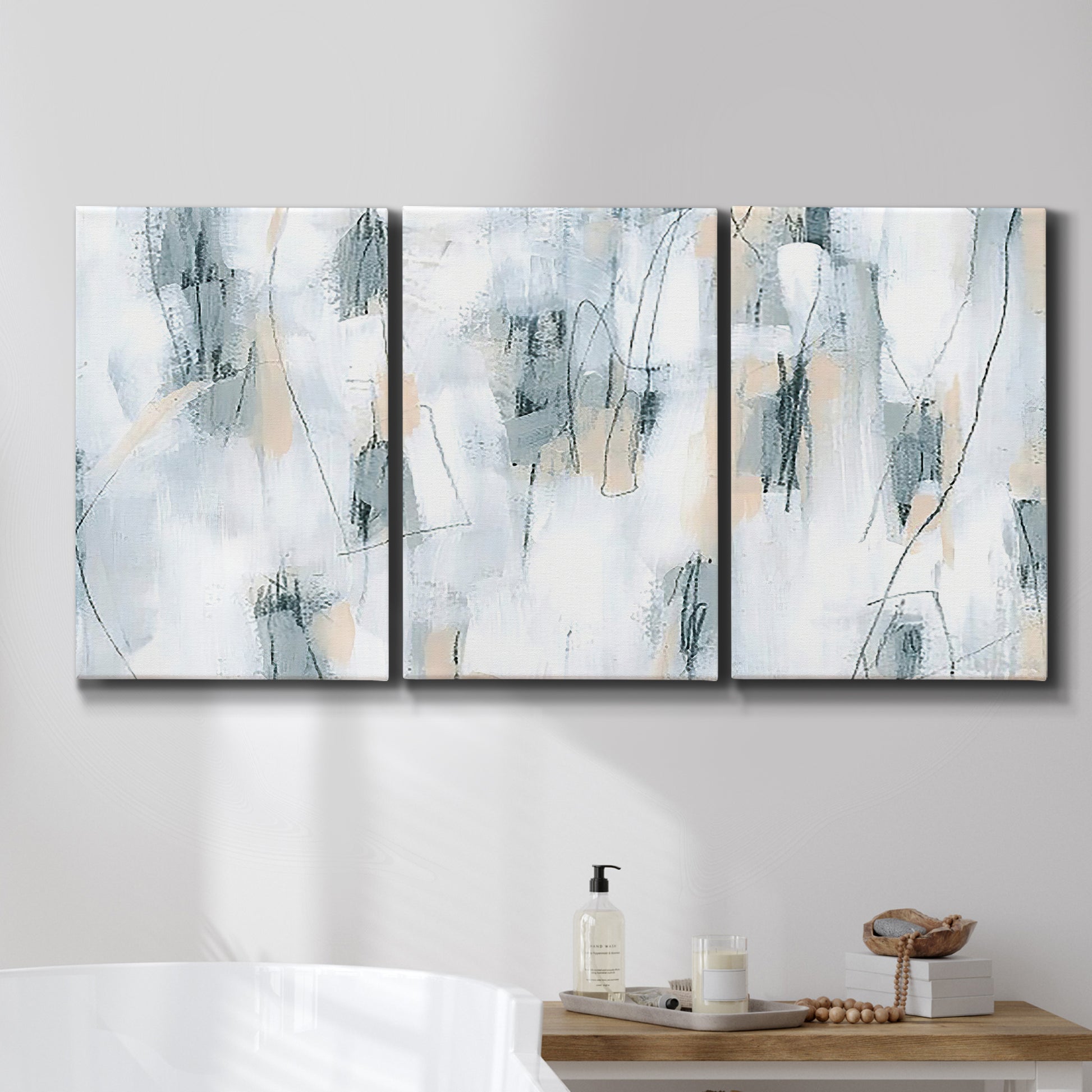 Three-panel canvas wall art featuring industrial textured abstract hatch patterns, displayed in a bathroom above a bathtub.