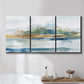 Three-panel canvas wall art featuring flowing blue abstract watercolor, displayed in a bathroom above a bathtub.