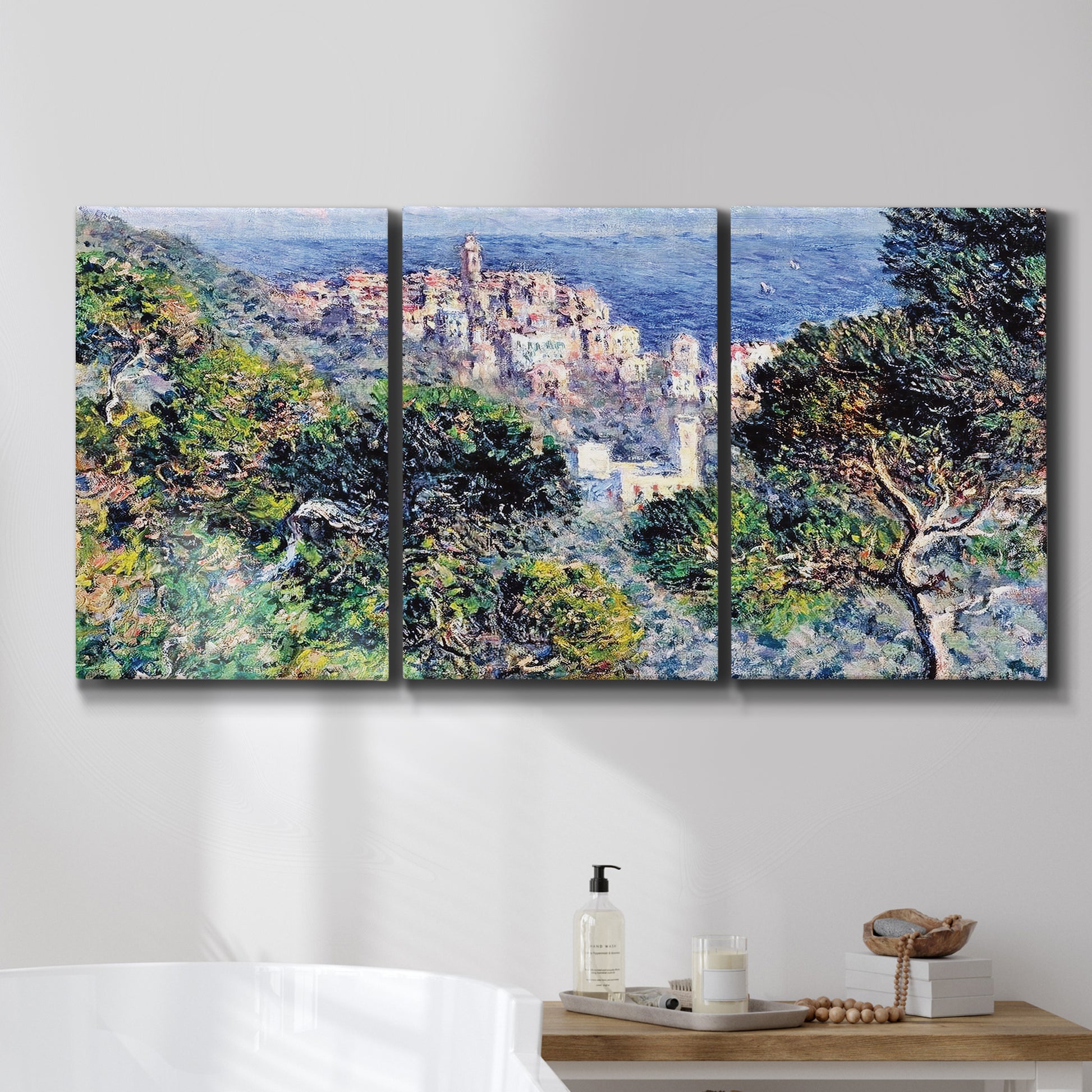Three-panel canvas wall art featuring coastal hillside overlooking monaco, displayed in a bathroom above a bathtub.