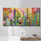 Three-panel canvas wall art featuring bold colorful floral abstraction, displayed in a bathroom above a bathtub.