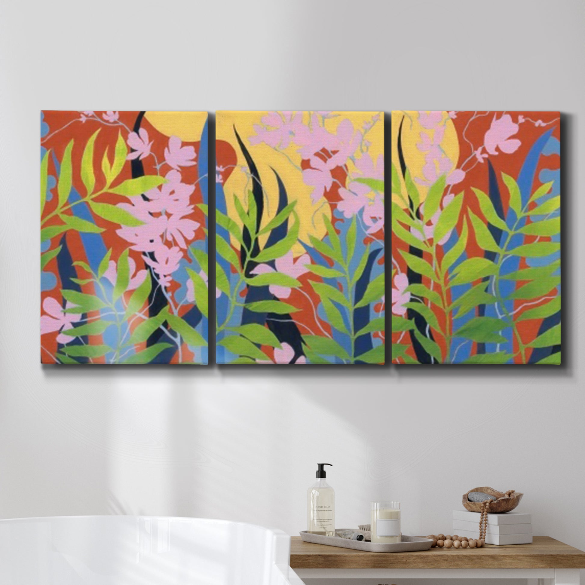 Three-panel canvas wall art featuring bold colorful floral abstraction, displayed in a bathroom above a bathtub.