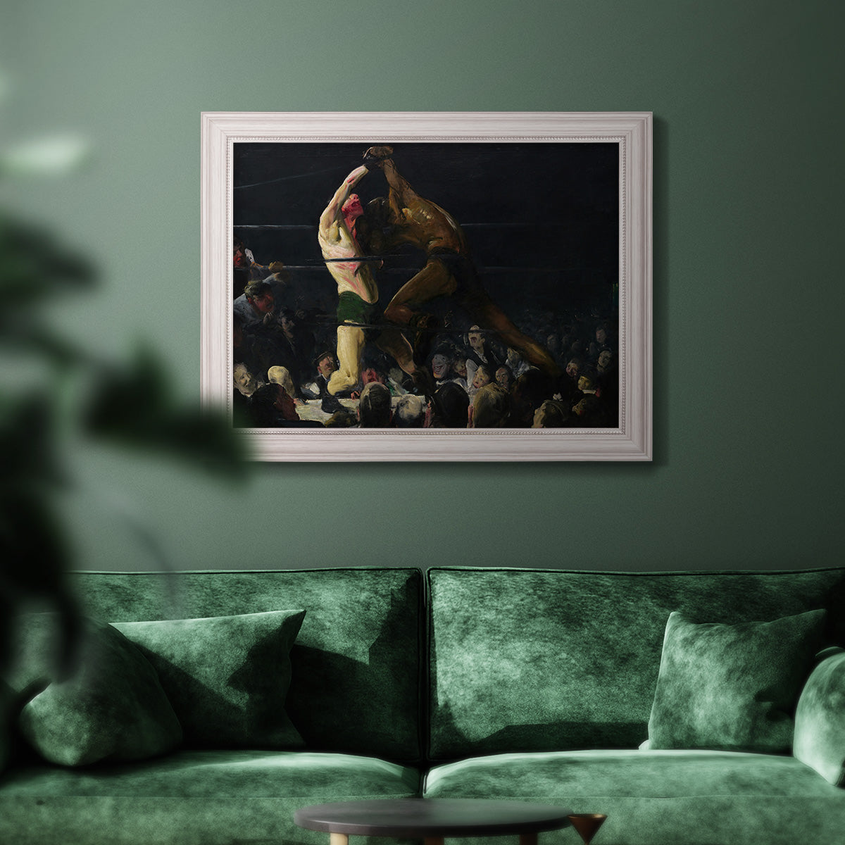 American genre painting of men in a social club by George Bellows in an ornate weathered white frame displayed in a dark-toned interior setting.