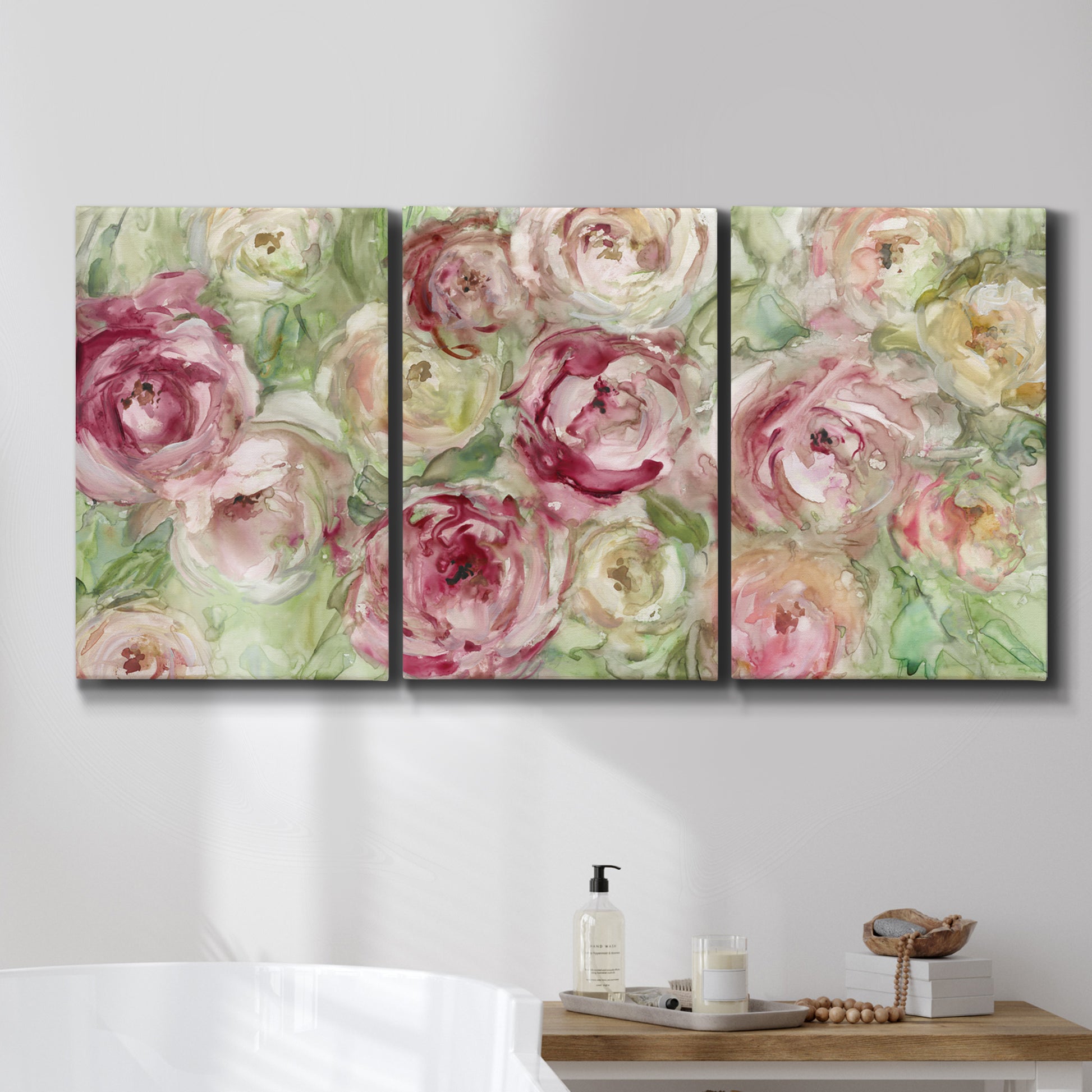 Three-panel canvas wall art featuring blooming climbing rose, displayed in a bathroom above a bathtub.