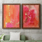 Set of two maple barnwood framed canvas prints depicting a coordinated art pair of luminous coral orange and pink color fields with gold flecks rendered as glamorous fluid abstracts above a sofa in a modern living room.