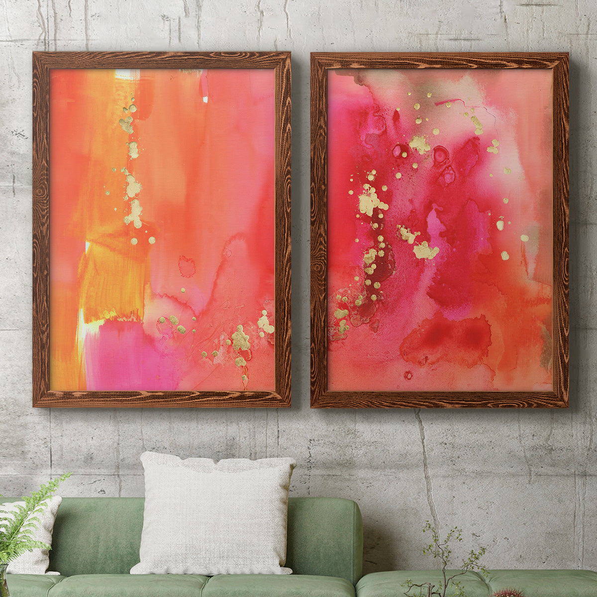 Set of two maple barnwood framed canvas prints depicting a coordinated art pair of luminous coral orange and pink color fields with gold flecks rendered as glamorous fluid abstracts above a sofa in a modern living room.
