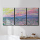 Three-panel canvas wall art featuring sunset reflections across calm sea, displayed in a bathroom above a bathtub.