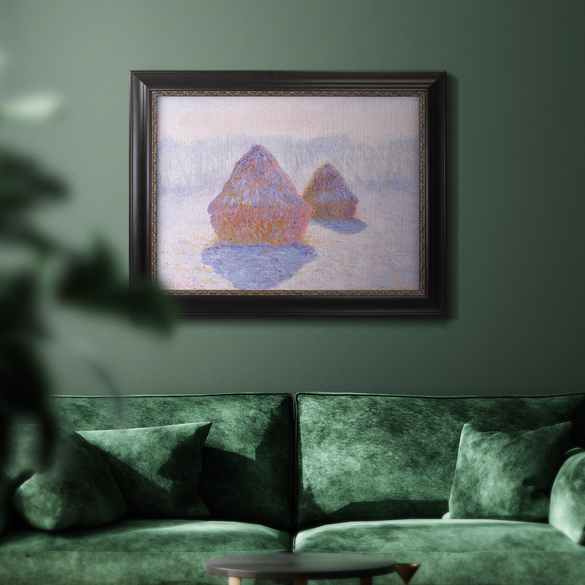 Impressionist winter haystack scene with sunlight by Claude Monet in an ornate black frame with gilded inner detail displayed in a dark-toned interior setting.