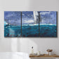 Three-panel canvas wall art featuring sailboats moving across water, displayed in a bathroom above a bathtub.