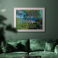 Impressionist Mediterranean coastal landscape by Claude Monet in an ornate weathered white frame displayed in a dark-toned interior setting.