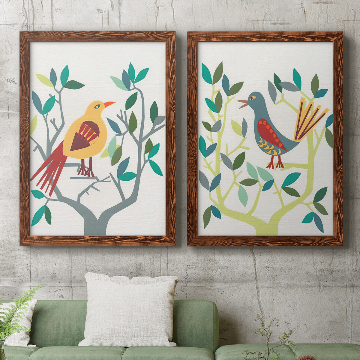 Set of two maple barnwood framed canvas prints depicting a coordinated art pair of stylized colorful birds perched among leafy branches rendered as modern folk-art bird illustrations above a sofa in a modern living room.