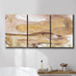 Three-panel canvas wall art featuring layered abstract dawn tones, displayed in a bathroom above a bathtub.