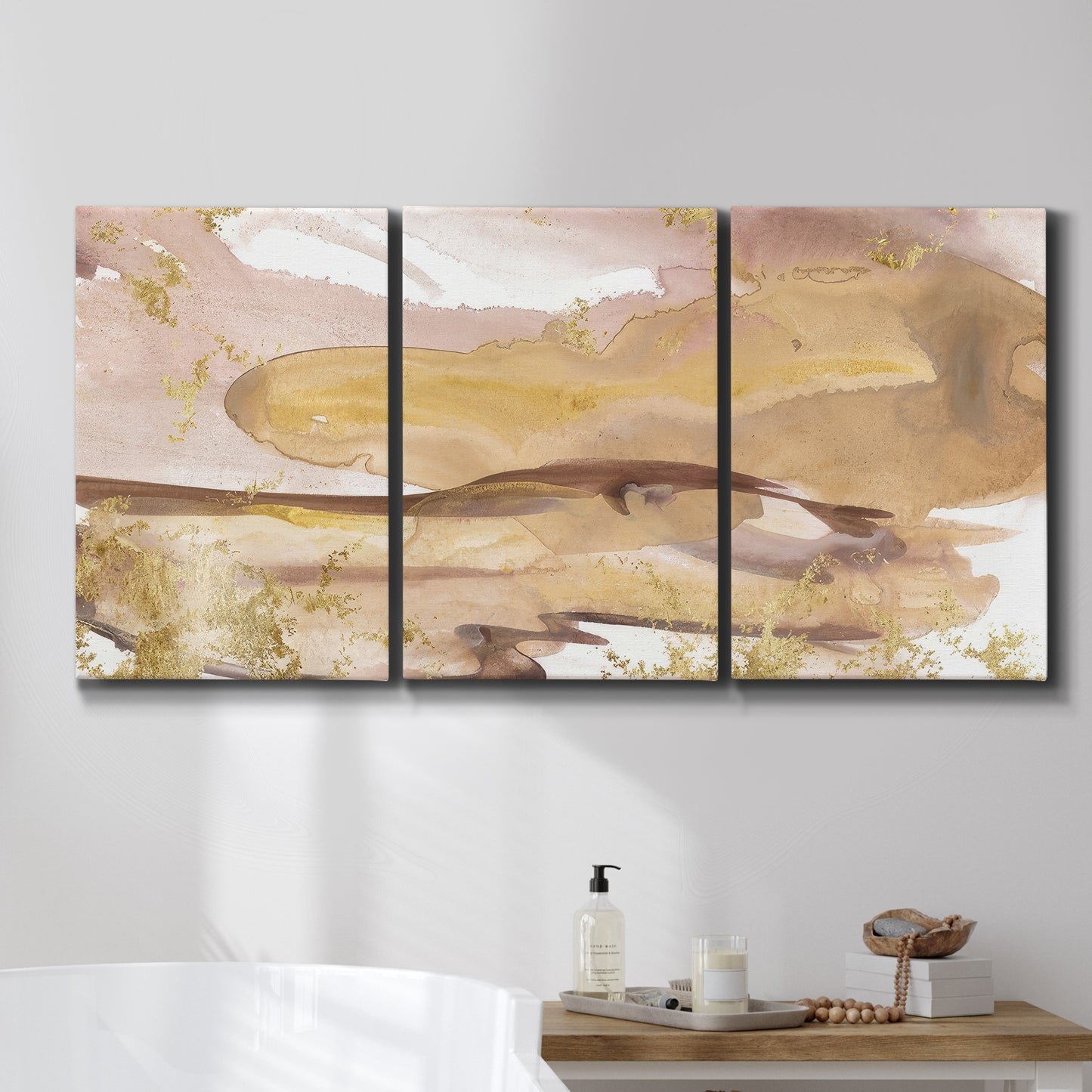 Three-panel canvas wall art featuring layered abstract dawn tones, displayed in a bathroom above a bathtub.