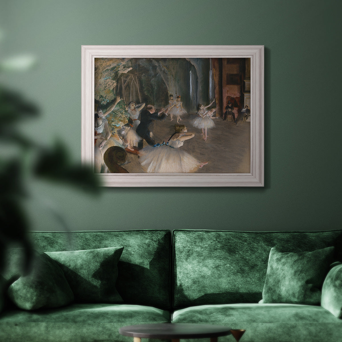 Impressionist backstage ballet scene by Edgar Degas in an ornate weathered white frame displayed in a dark-toned interior setting.