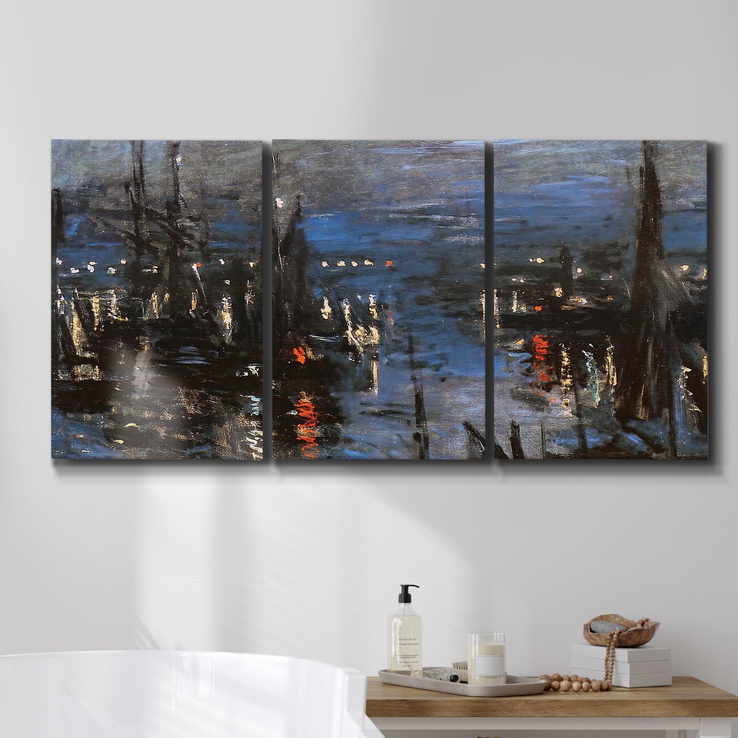 Three-panel canvas wall art featuring Le Havre port at night with lights, displayed in a bathroom above a bathtub.